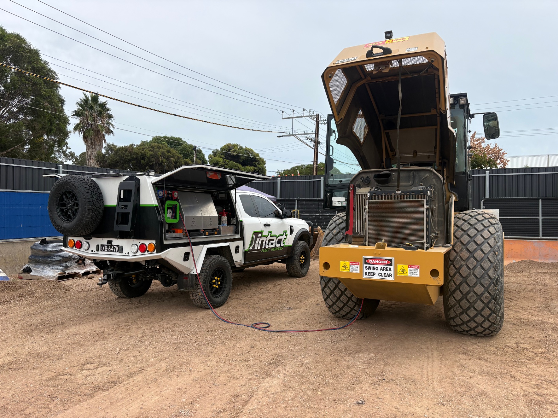 Intact Fleet Services ute servicing the air conditioning system on a wheel loader